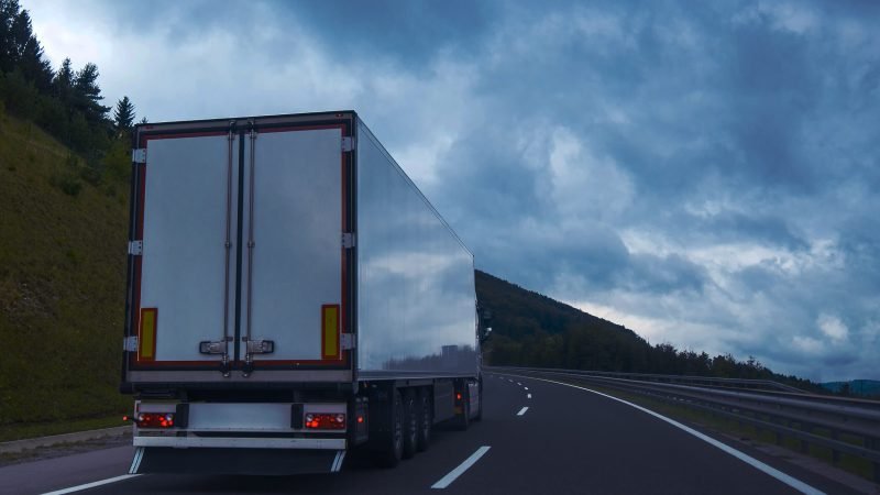 Semi truck with trailer on highway road